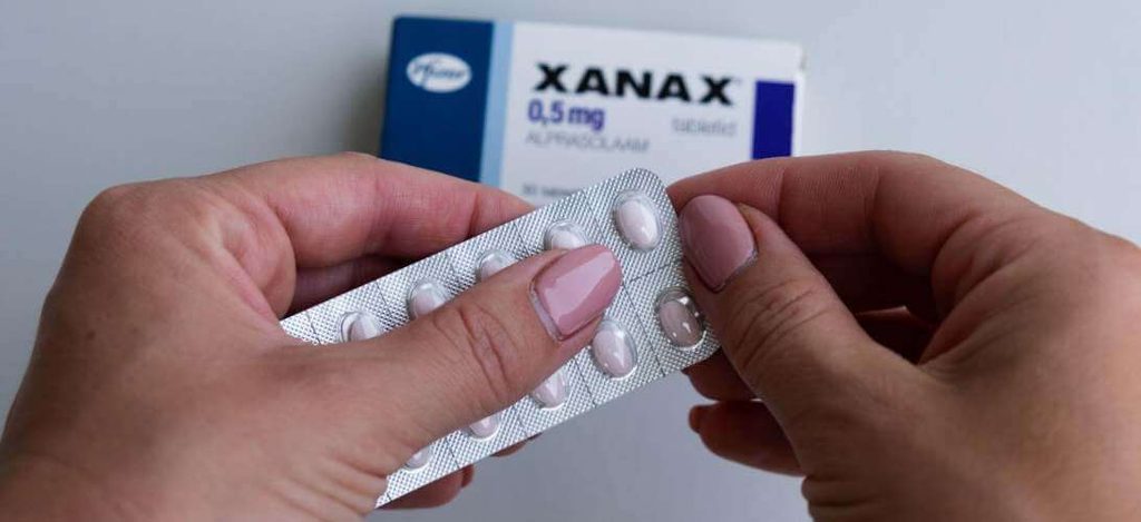 Pharmacist reviewing prescription medication information with a patient